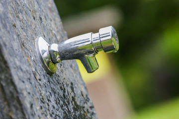 Water flowing from a tap in nature