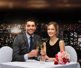 couple with glasses of champagne at restaurant