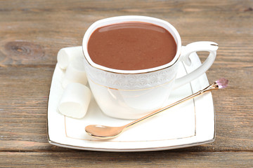Cup of hot chocolate on table, close up