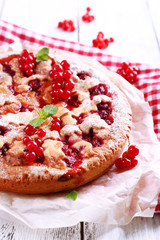 Tasty cake with berries on table close-up