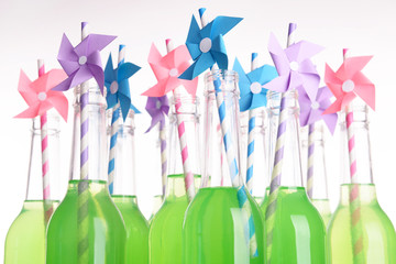 Bottles of drink with straw isolated on white