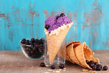 Tasty ice cream with berries in waffle cone