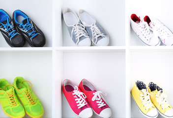 Colorful shoes on wooden shelves