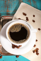 Cup of coffee on color wooden background