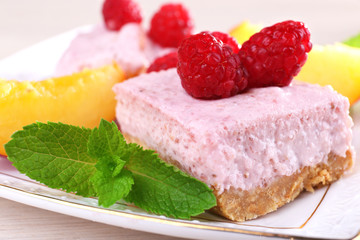 Cake with fruits and berries on plate on wooden background