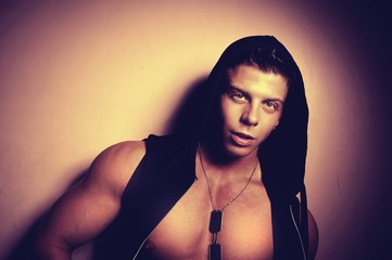 Handsome guy posing in hood. Bodybuilder