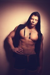 Fototapeta na wymiar Handsome guy posing in hood. Bodybuilder