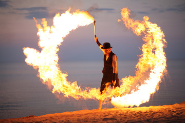 Awesome fire show on the beach; circle of flame