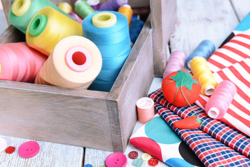 Sewing Accessories in wooden box on table close-up