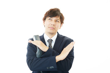禁止の意思表示をするビジネスマン