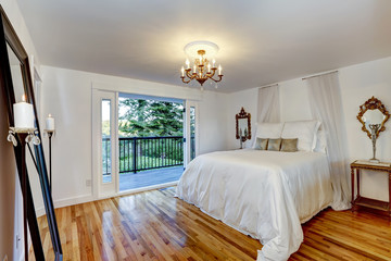 White bedroom interior with walkout deck