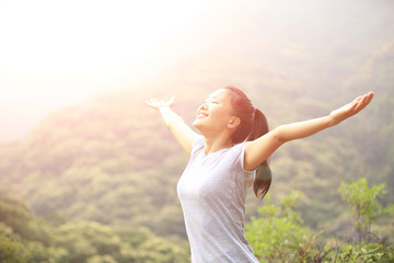 cheering hiking woman open arms mountain peak