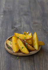 Baked new potatoes on wooden background