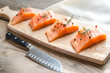 Raw salmon steaks on the wooden board