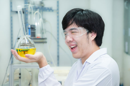 Asian researcher carrying out experiments in a laboratory - look