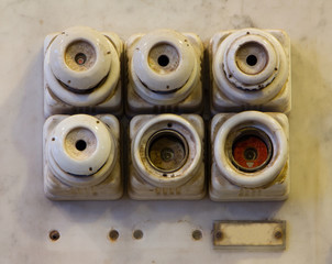 The old ceramic fuses on a wall
