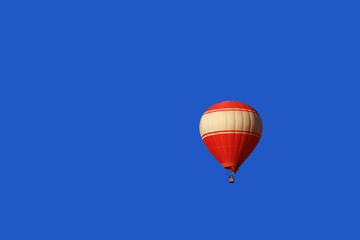 Red balloon isolated on blue sky.
