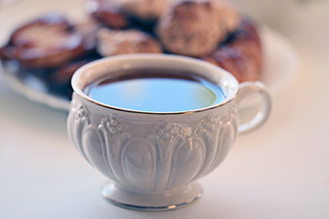 white cup of tea with cookies