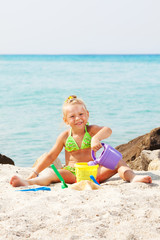 Little girl playing on the beach