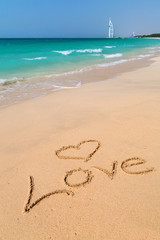 Love sign on the beach with turquoise water