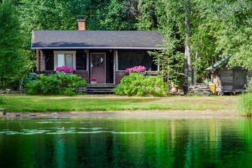 Old Finnish summer cottage at a lake © nblxer