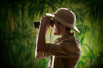 Young explorer looking through binoculars