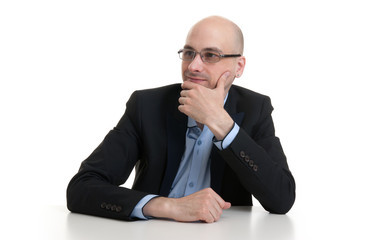 portrait of a cheerful businessman sitting at a table