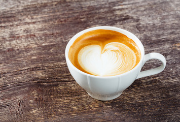 Cup of coffee on old wooden table