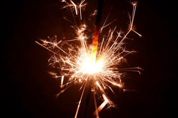 Fototapeta premium Christmas sparkler on black background. Bengal fire