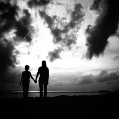 Zelfklevend Fotobehang mother and son in silhouette © nasruleffendy