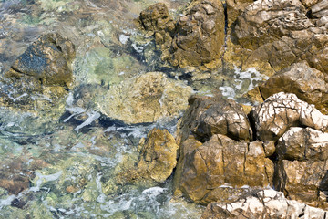 Close up of sea waves splashing stones