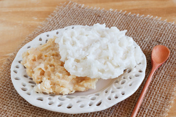 Coconut candy cocada on sackcloth  on wooden table