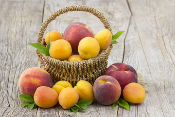 Naklejka na ściany i meble fresh fruits in a basket on wooden background
