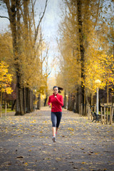 Obraz premium Woman running in autumn park