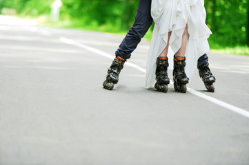 the groom and the bride skate on roller-skaters