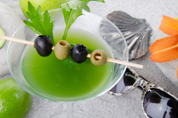 Healthy green vegetables cocktail on a beach environment