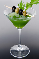 Green vegetables cocktail on a gray background