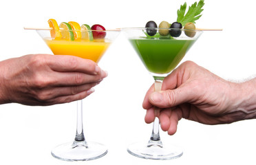Woman's and man's hand making toast with glasses of cocktails