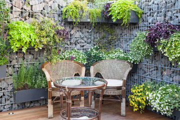 Small patio or city garden with rustic chairs and table