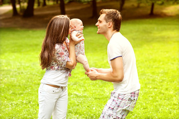 Fototapeta premium parents with baby in park