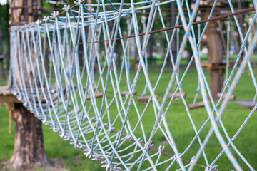 The bridge of logs tied to the ropes, part of a ropes course