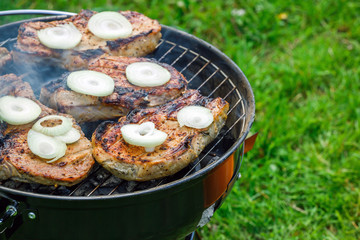 Grilling steaks at summer weekend
