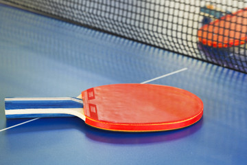 two red tennis racket on ping pong table