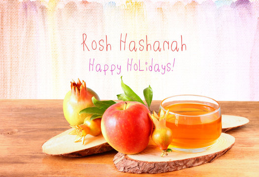 rosh hashanah concept - apple honey and pomegranate over wooden 