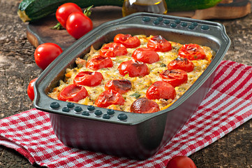 Baked pudding from a young zucchini, carrots, onions and chicken