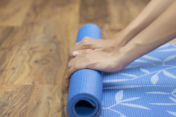 Young woman holding a yoga mat