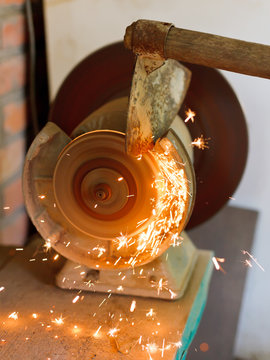 sharpening garden hoer using a grinding machine