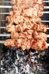 skewers with shish kebabs over burning coal