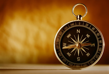 Magnetic compass against a vintage background © sergign