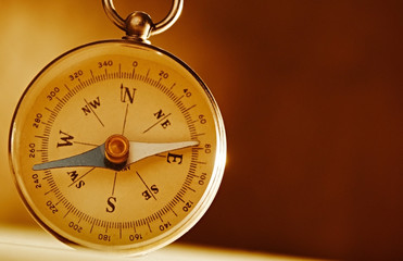 Magnetic compass against a vintage background